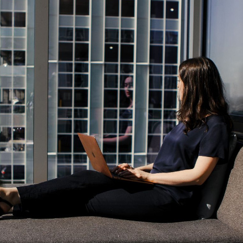 working at laptop in a window